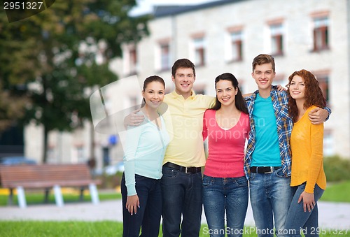 Image of group of smiling teenagers over campus background