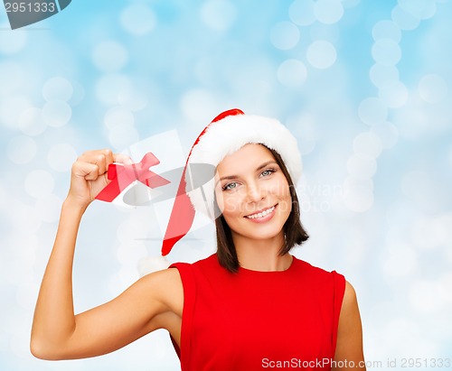Image of smiling woman in santa hat with jingle bells