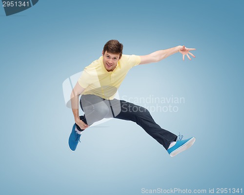 Image of smiling young man jumping in air