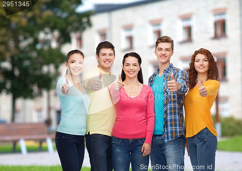 Image of group of smiling teenagers over campus background