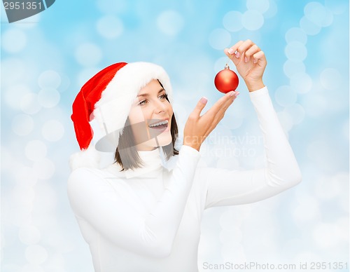 Image of woman in santa helper hat with christmas ball