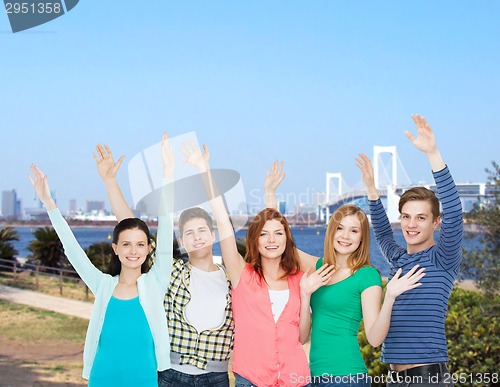 Image of group of smiling students waving hands