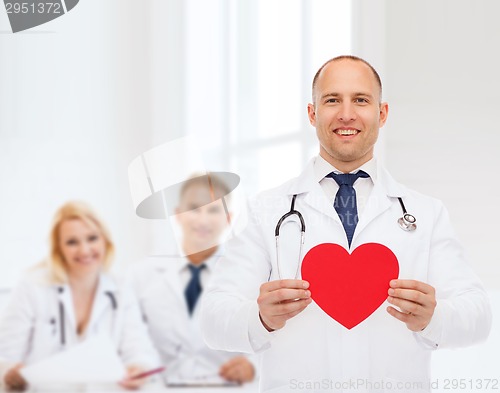 Image of smiling male doctor with red heart and stethoscope