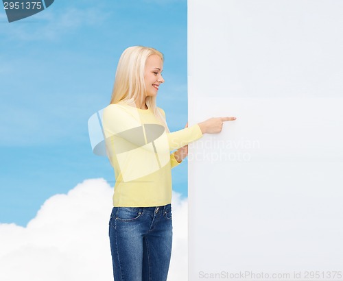 Image of smiling woman in sweater with blank white board