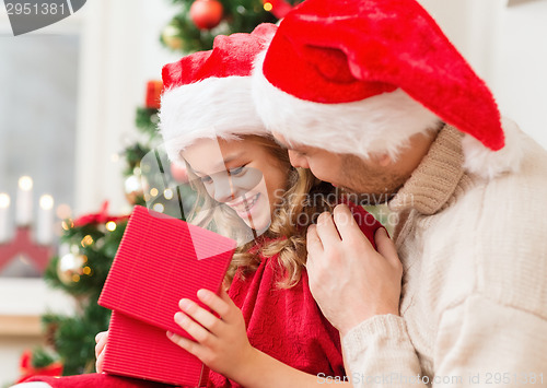 Image of smiling father and daughter opening gift box