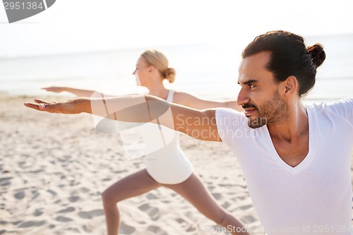 Image of close up of couple making yoga exercises outdoors