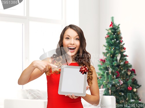 Image of smiling woman in red dress with tablet pc