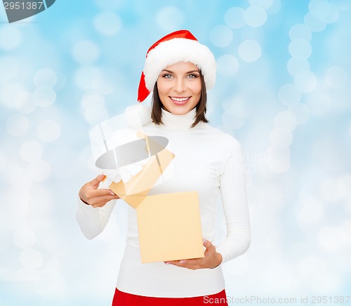 Image of smiling woman in santa helper hat with gift box