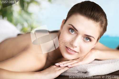 Image of woman in spa salon with hot stones