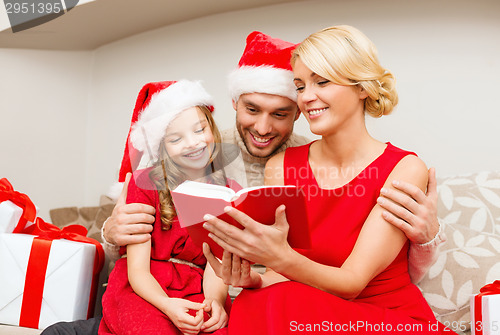 Image of smiling family reading book