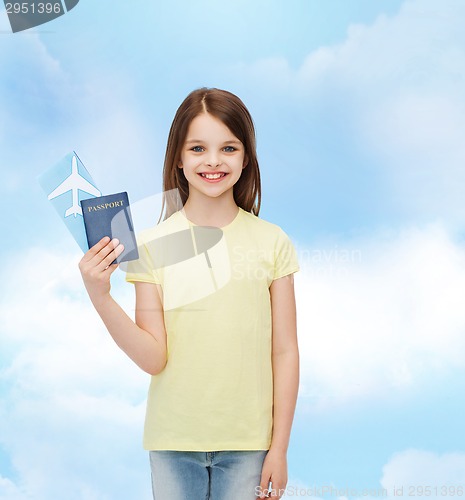 Image of smiling little girl with ticket and passport