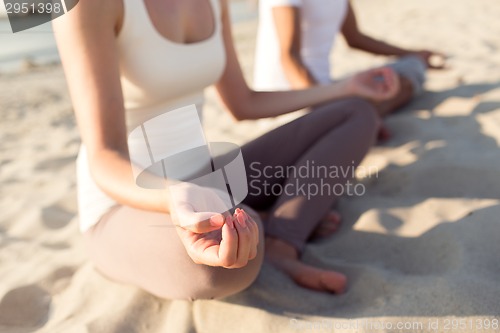 Image of close up of couple making yoga exercises outdoors