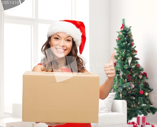 Image of smiling woman in santa helper hat with parcel box