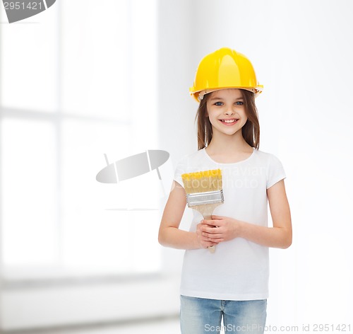 Image of smiling little girl in helmet with paint roller