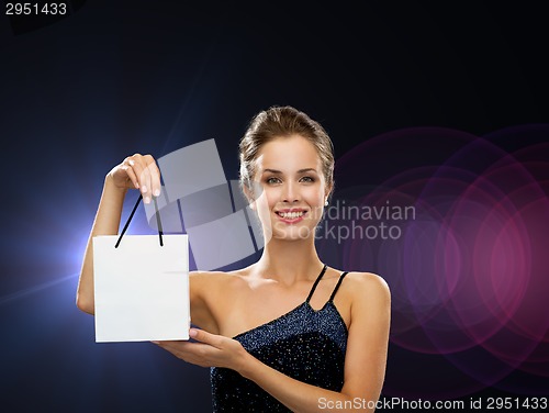 Image of smiling woman with white blank shopping bag