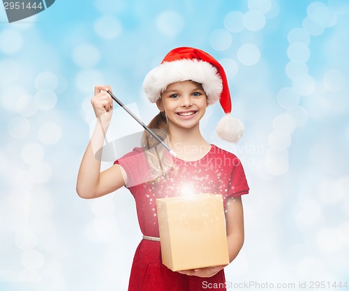 Image of smiling girl in santa helper hat with gift box