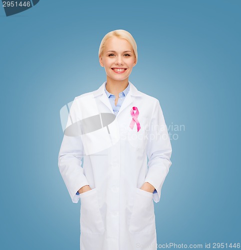 Image of smiling female doctor with cancer awareness ribbon