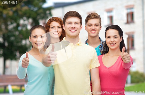 Image of group of smiling teenagers over campus background