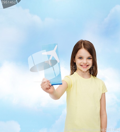 Image of smiling little girl with airplane ticket