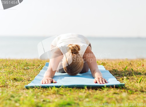 Image of close up of woman making yoga exercises outdoors