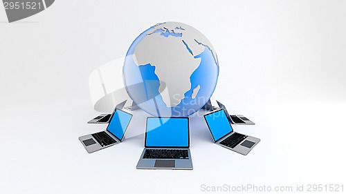 Image of Laptops around globe. Global network concept.