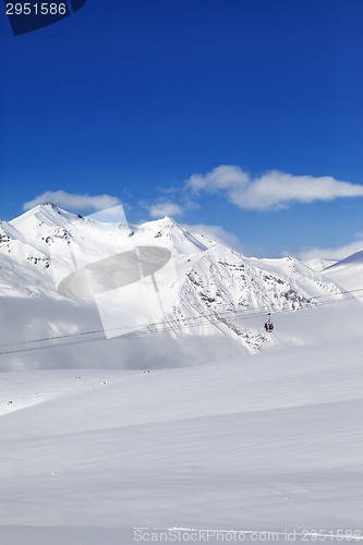 Image of Winter snowy mountains and ski slope at nice day.