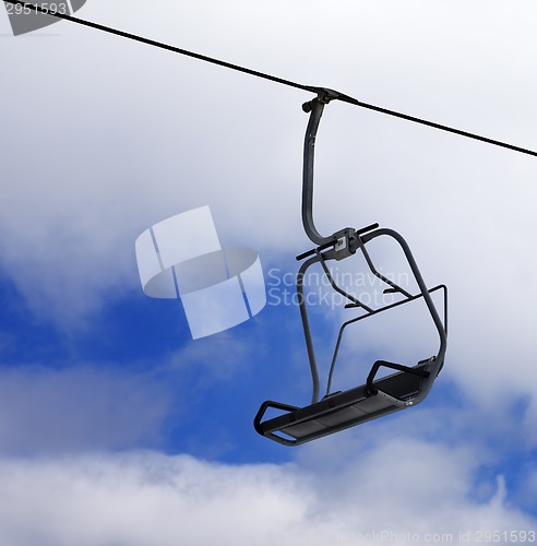 Image of Chair-lift and cloudy sky