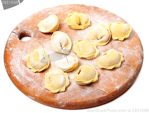 Image of Raw homemade ravioli on wooden cutting board