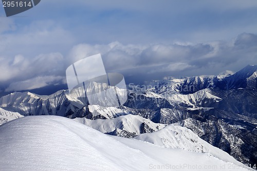 Image of Off-piste snowy slope and mountains in cloud