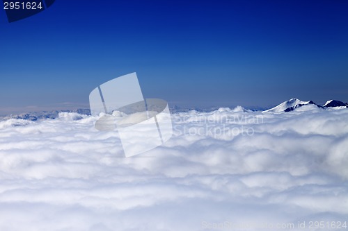 Image of Mountains under clouds in sun winter day