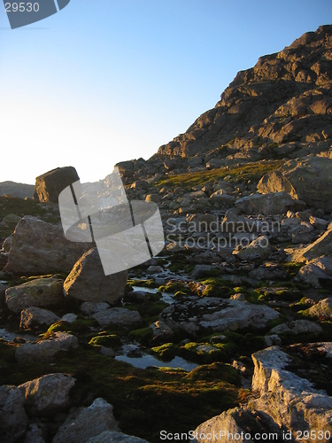 Image of rocky hillside with small river