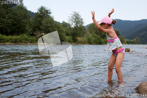 Image of Girl throwing stone