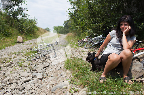 Image of Woman with her ??dog resting