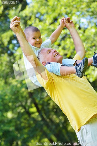 Image of happy grandfather and child in park