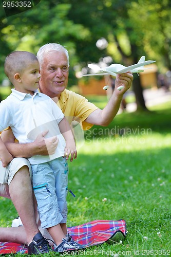 Image of happy grandfather and child in park
