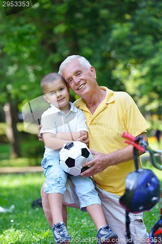 Image of happy grandfather and child in park