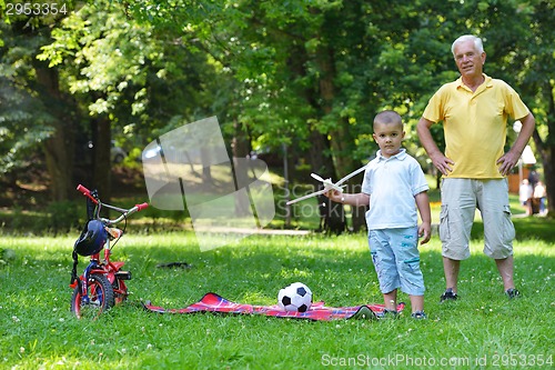 Image of happy grandfather and child in park