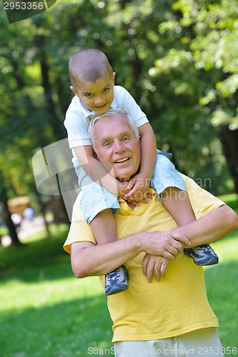 Image of happy grandfather and child in park