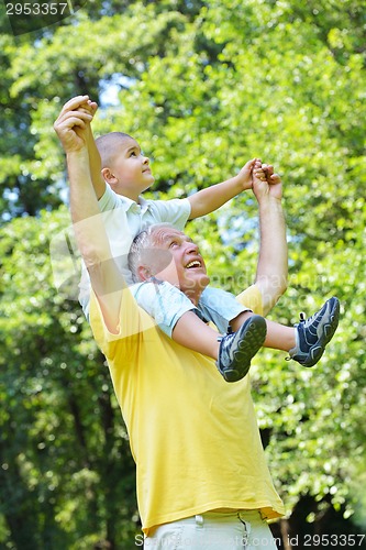 Image of happy grandfather and child in park