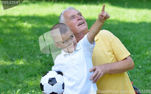 Image of happy grandfather and child in park