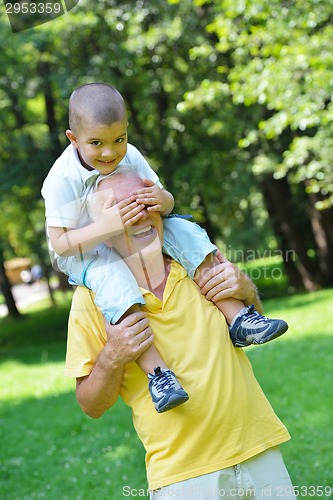 Image of happy grandfather and child in park