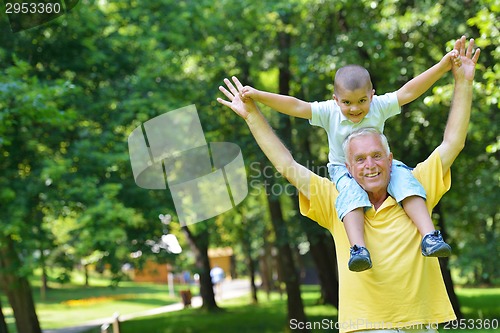 Image of happy grandfather and child in park