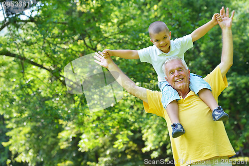 Image of happy grandfather and child in park