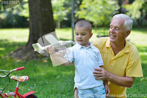 Image of happy grandfather and child in park