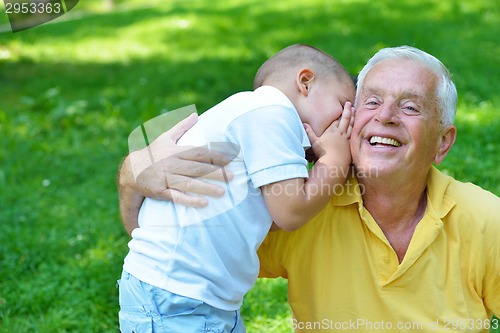 Image of happy grandfather and child in park