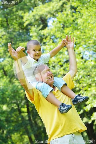 Image of happy grandfather and child in park