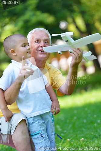Image of happy grandfather and child in park