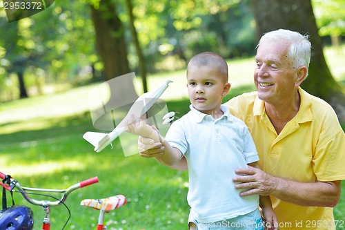 Image of happy grandfather and child in park