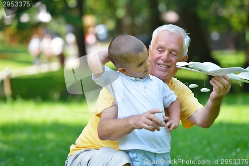 Image of happy grandfather and child in park
