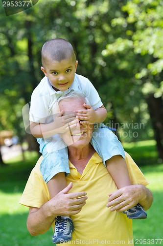 Image of happy grandfather and child in park